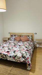 a bedroom with a bed with a colorful comforter at La Casa del Borgo in Rieti +9 photos