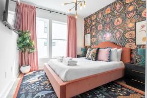 a bedroom with an orange bed with a floral wall at Chloe at The Lucy by Stay Local Nashville in Nashville