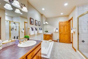 a bathroom with a sink and a tub and a shower at Walk to Gondola Condo with Deck in Winter Park! in Winter Park