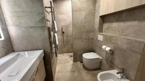 a bathroom with a toilet and a sink at Casa Luca in Carvoeiro