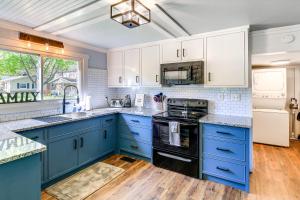 a kitchen with blue cabinets and white appliances at Walk to River and Trails Cozy Damascus Cottage! in Damascus