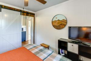 a bedroom with a bed and a flat screen tv at Walk to River and Trails Cozy Damascus Cottage! in Damascus +16 photos