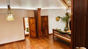 a living room with a table and a mirror at Floating Villa near Nzulezu in Beyin