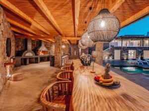 a large room with a table and chairs and a pool at Shark Luxury Villa in Agios Ioannis Mykonos