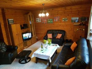 a living room with a couch and a table at 1-bedroom apartment in Amelinghausen