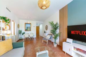a living room with a couch and a tv at Jardín privado # NETFLIX # Playa a 8min # WIFI # Familia # Apartamento in Vera +14 photos