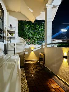 a patio with a table and a window at night at Rattanasup House in Hat Yai