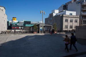 a group of people walking down a street at Hostal A Pedra in Vigo