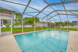 a swimming pool with a metal canopy over it at Private Pool and Lanai Family Home in Haines City! in Haines City