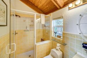 a bathroom with a toilet and a glass shower at Oceanfront Irish Beach Home Private Beach Access! in Manchester