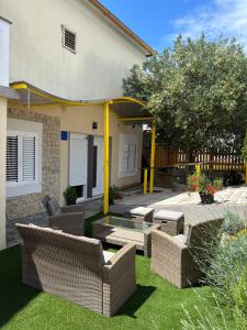 un patio con sillas de mimbre y una mesa en un patio en Studio apartman Sedmica, en Zadar 6 fotos más
