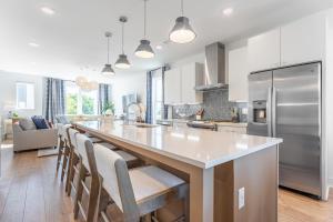 a kitchen with a large island with chairs and a counter top at Henley at The Lucy by Stay Local Nashville in Nashville