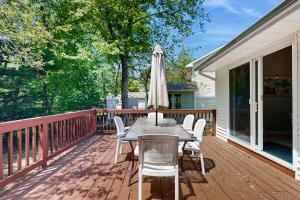 a wooden deck with a table and an umbrella at Candlelight Acres - 530 Candlelight in Bethany Beach