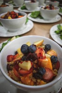a bowl of fruit on a table with other plates of food at Nalanda SPA & Casa de Montaña in Patate +25 photos