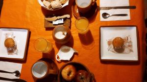 a table with plates of food and fruit on it at Casa Suyay in Tilcara