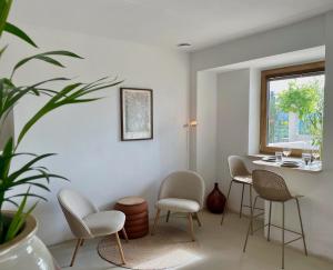 a room with chairs and a table and a window at Vipava View Studio Apartments in Šempas +33 photos