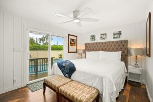 a bedroom with a bed with a ceiling fan and a window at Emmalani 3BR Princeville Villa with Private Pool in Princeville +52 photos