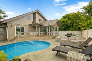 a swimming pool with chairs and a house at Emmalani 3BR Princeville Villa with Private Pool in Princeville