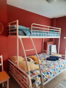two bunk beds in a room with a red wall at HYPER CENTRE DE MARSEILLE VIEUX PORT in Marseille