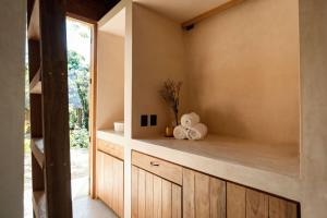 a kitchen with wooden cabinets and a window at Casa Xul in Tulum +55 photos