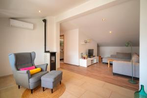 a living room with a chair and a bed at Apartments Dulcic in Stari Grad