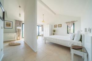 a white bedroom with a large bed and a tub at Klinci Village Resort in Lustica +79 photos
