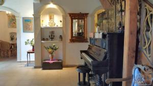 a living room with a piano in a room at Painter's House Historic Stone Villa with Sea View in Perast
