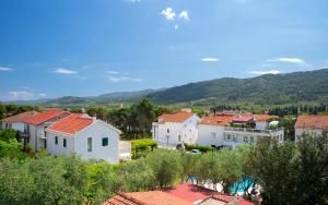 a group of houses with mountains in the background at Apartments Dulcic in Stari Grad