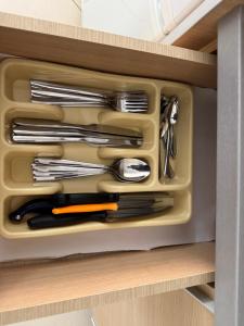 a drawer filled with utensils in a kitchen at Comfort 1 Apartment in Sarandë