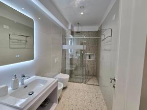 a bathroom with a shower and a sink and a toilet at David's Studio Stays in Vlorë +24 photos