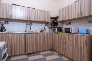 a kitchen with wooden cabinets and a sink at Résidence Koto in Dakar