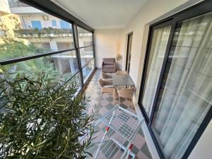 an apartment balcony with a table and chairs and windows at David's Studio Stays in Vlorë