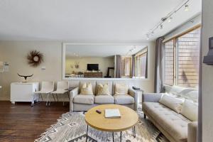 a living room with a couch and a table at Cozy Coyote Fork Condo in Truckee