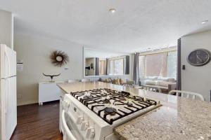 a kitchen with a stove top oven in a room at Cozy Coyote Fork Condo in Truckee