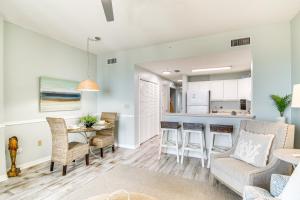 a living room and kitchen with a table and chairs at Walk to Beach Condo with Balcony in Gulf Shores! in Gulf Shores