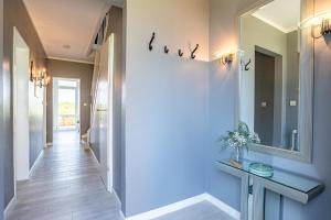 a hallway with a sink and a mirror at Dünennest in Südstrand +25 photos