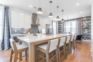 a kitchen with a large kitchen island with chairs at Mira at The Lucy by Stay Local Nashville in Nashville