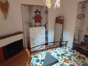 a bedroom with a bed and a lighthouse on the wall at Happy Day Beach House in Costa da Caparica +40 photos