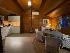 a kitchen and dining room with a table and chairs at Het Horste Huisje in Enschede +8 photos