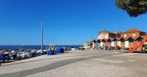 a parking lot with a row of parked cars and houses at Brisa do Mar Vila Chã in Vila Chã