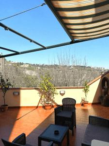 a patio with chairs and tables on a balcony at Terrazza Paradiso in Naples +15 photos