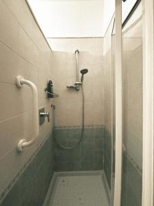 a bathroom with a shower with a glass door at Terrazza Paradiso in Naples