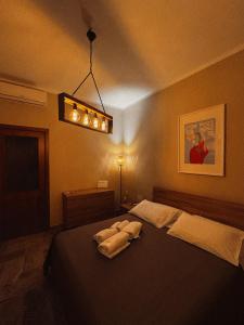 a bedroom with a bed with two towels on it at Terrazza Paradiso in Naples
