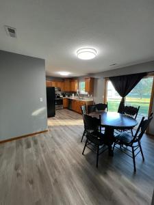 a dining room and kitchen with a table and chairs at Relax Enjoy Mid-Missouri with Fenced in Back Yard in Boonville