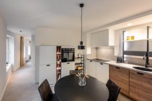 a kitchen with a table and chairs in a kitchen at Borgraaf - Fruitzicht in Borgloon