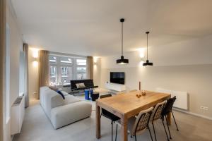 a living room with a table and a couch at Borgraaf - Fruitzicht in Borgloon