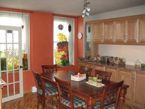 a kitchen with a wooden table and wooden chairs at Le 253 in Quebec City