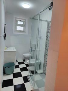 a bathroom with a glass shower and a toilet at Blue House Amadora City in Amadora +43 photos