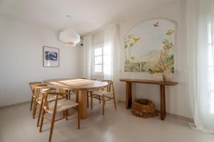a dining room with a table and chairs at Mosaico Ocean View Boutique Apartment in Adeje