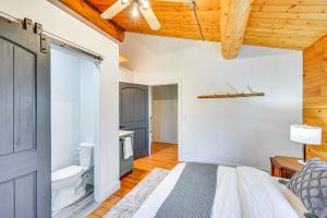a bedroom with a bed and a bathroom at 4 Mi to Dtwn Spacious Family Cabin in Jonesville! in Jonesville +25 photos